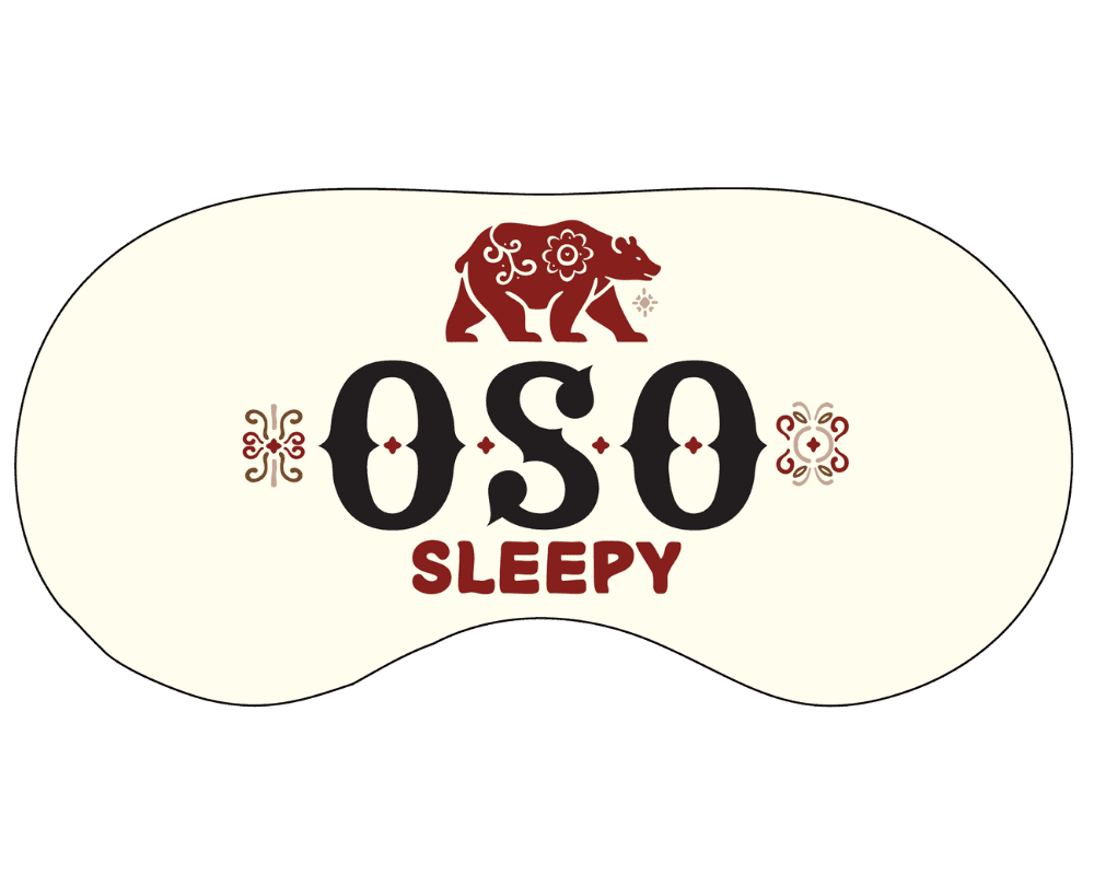 A sleep mask featuring the words "OSO SLEEPY" with a bear illustration and decorative elements.
